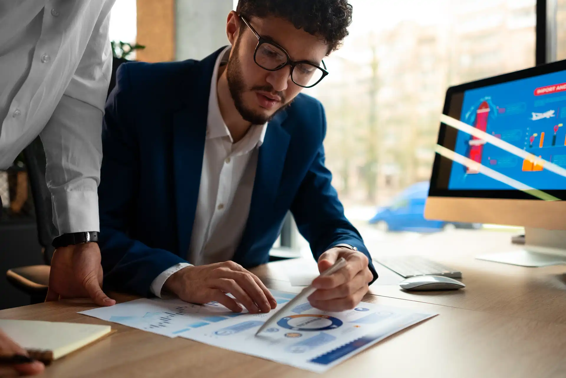 Workspace with charts, notes, and coding sheets used to develop a strong qualitative research design for academic projects.