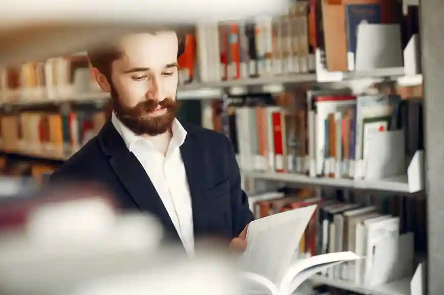 Professional researcher drafting a research project proposal with organized study materials.